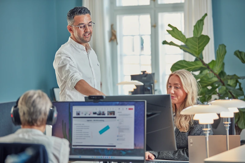 Colleagues - Three people talking in an office